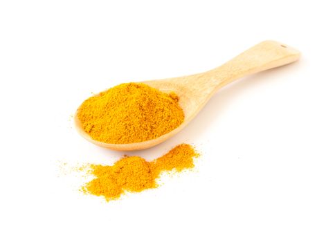 Turmeric power on wooden spoon with white background, herb and healthy care concept