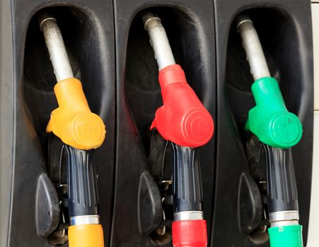 Gas pump nozzles at a gasoline station