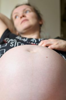 Big belly of pregnant woman closeup, nine month