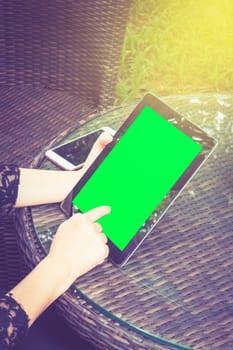 business woman working on tablet. tablet with green screen ready.