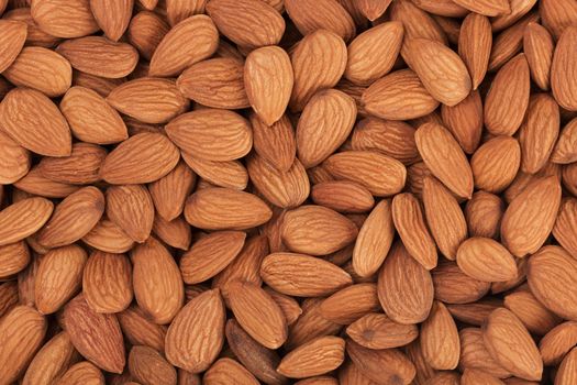 Pile of almonds close-up as background. food texture