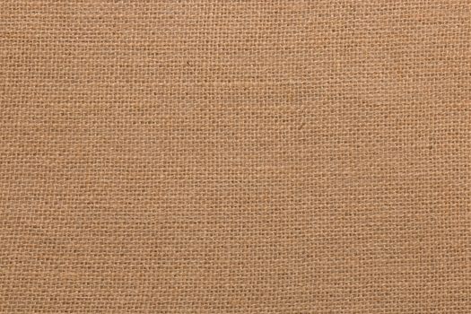 Burlap background and texture, The texture of the burlap, closeup with yellow tint