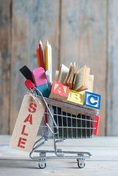 Shopping cart filled with stationery with background space