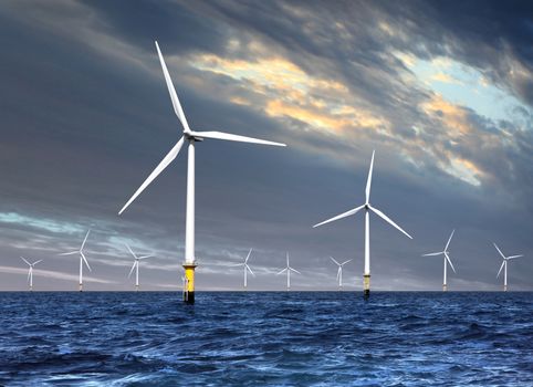 wind turbines generating electricity on sea under cloud sky