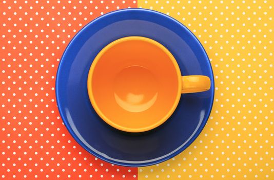 Dish and cup with colorful topped background