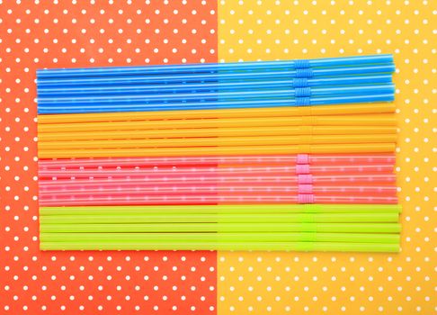 Straws with colorful topped background