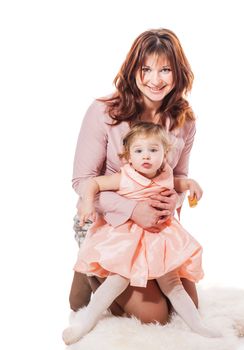 Mother holding ywo years daughter isolated on white