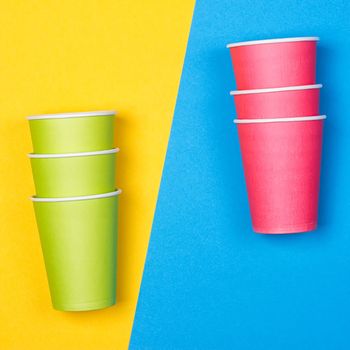 Paper cups on the Yellow and blue background. minimalism.