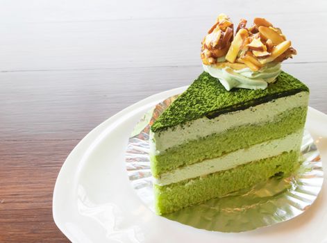Closeup matcha green tea cake in coffee shop with nature background