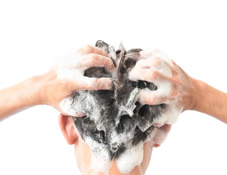 Closeup young man washing hair with white background, health care concept