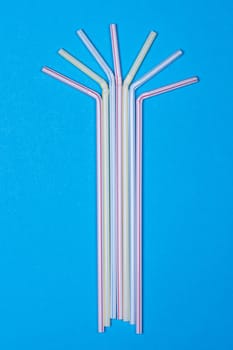 close-up colorful fancy drinking straws, fancy tube for party on the blue background