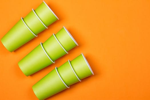 recycling colorful paper glass on the orange background