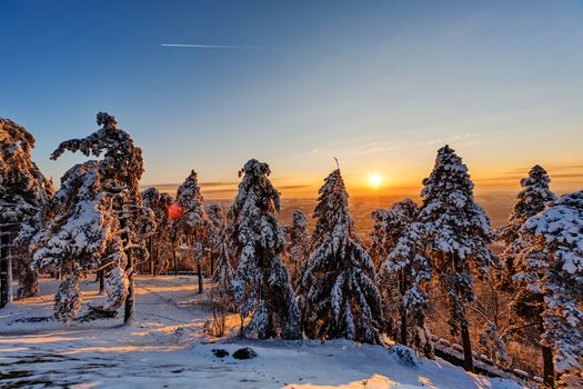 Sunset at mountain with airplain passing by