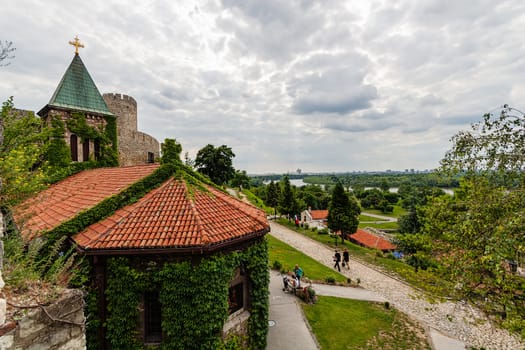 Belgrade fortress and Kalemegdan park with dramatic clouds and green foliage