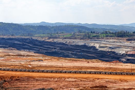 Open coal mining pit with heavy machinery