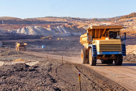 Open coal mining pit with heavy machinery