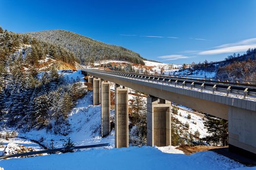 Mountain bridge in winter with snow and blue sky, Zlatibor mountain, Serbia