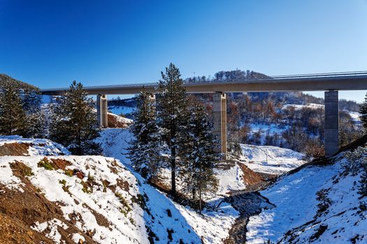 Mountain bridge in winter with snow and blue sky, Zlatibor mountain, Serbia