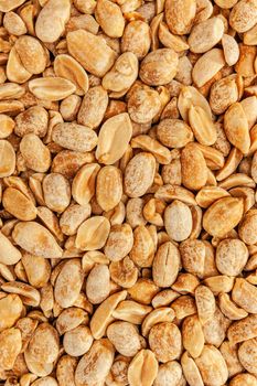 Roasted peanuts in closeup on the white background