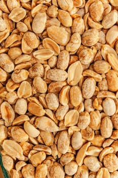 Roasted peanuts in closeup on the white background