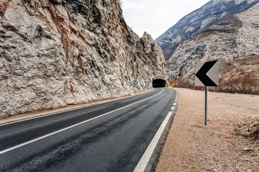 Tunnel on the road in the canyon during the winter on a cloudy day