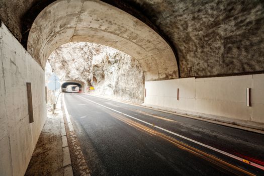 Tunnel on the road in the canyon during the winter on a cloudy day