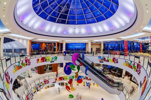 Interior of shopping mall with people walking