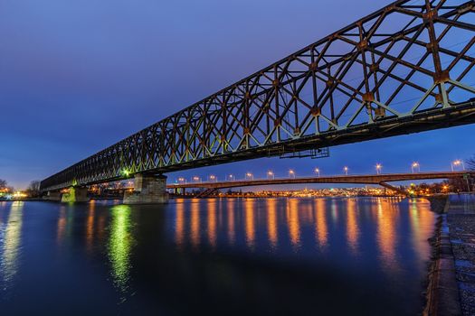 Steel bridge across river at night