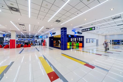 Interior of shopping mall with people walking