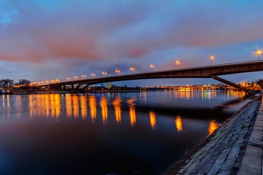 Steel bridge across river at night