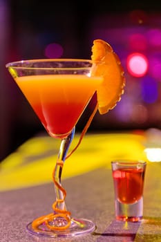 Close up of cocktail at the bar in a night club with vivid colors