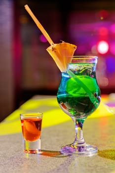 Close up of cocktail at the bar in a night club with vivid colors