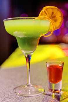 Close up of cocktail at the bar in a night club with vivid colors