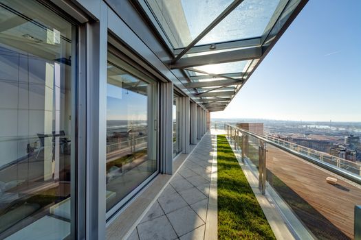 Terrace with metal and glass construction in modern building