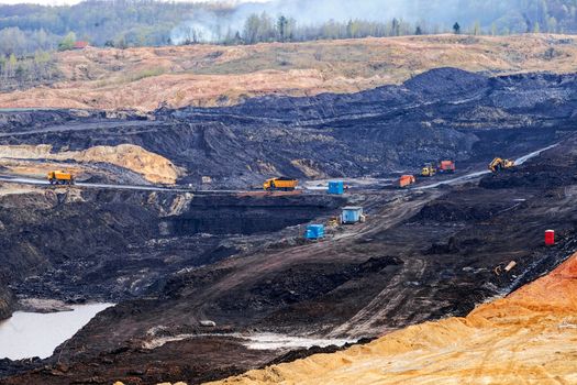 open mining pit with heavy machinery