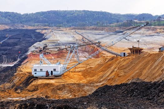 open coal mining pit with heavy machinery