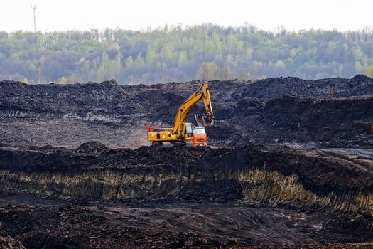 open coal mining pit with heavy machinery