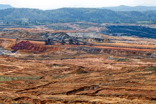 open mining pit with heavy machinery