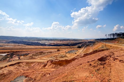 open mining pit with heavy machinery