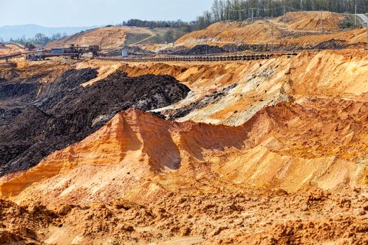 open coal mining pit with heavy machinery