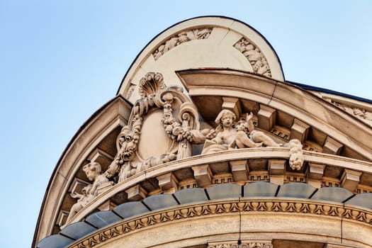 stone facade on classical building with ornaments and sculptures