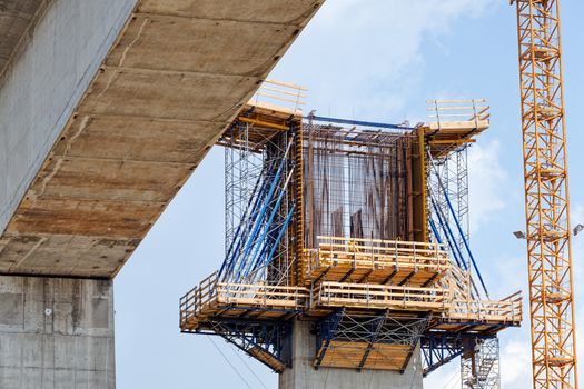 high altitude concrete bridge construction with crane and framework