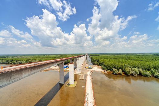 high altitude concrete bridge construction with crane and framework