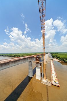 high altitude concrete bridge construction with crane and framework