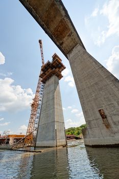 high altitude concrete bridge construction with crane and framework