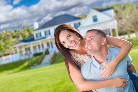 Playful Young Military Couple Outside A Beautiful New Home.