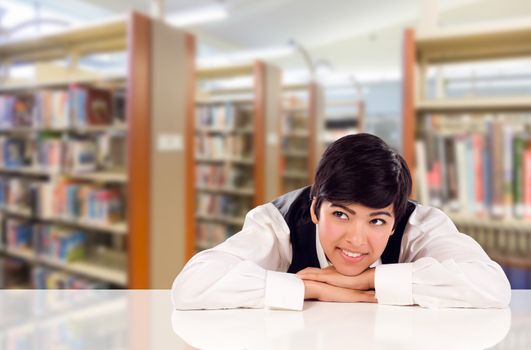 Young Female Mixed Race Student Daydreaming In Library Looking To the Left.