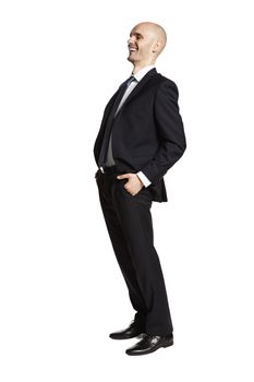 Side view of laughing young man in black suit isolated on white background.
