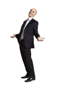 Side view of laughing young man in black suit on white background.