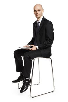 Portrait of bored young office worker sitting on the chair. Isolated on white background.